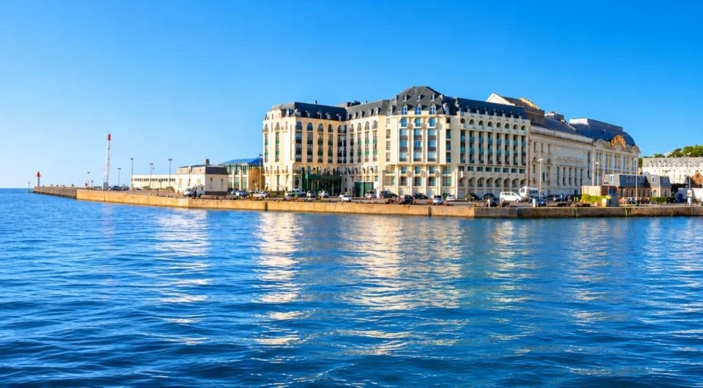 Façade élégante d'un hôtel belle époque au bord de l'eau avec architecture classique.